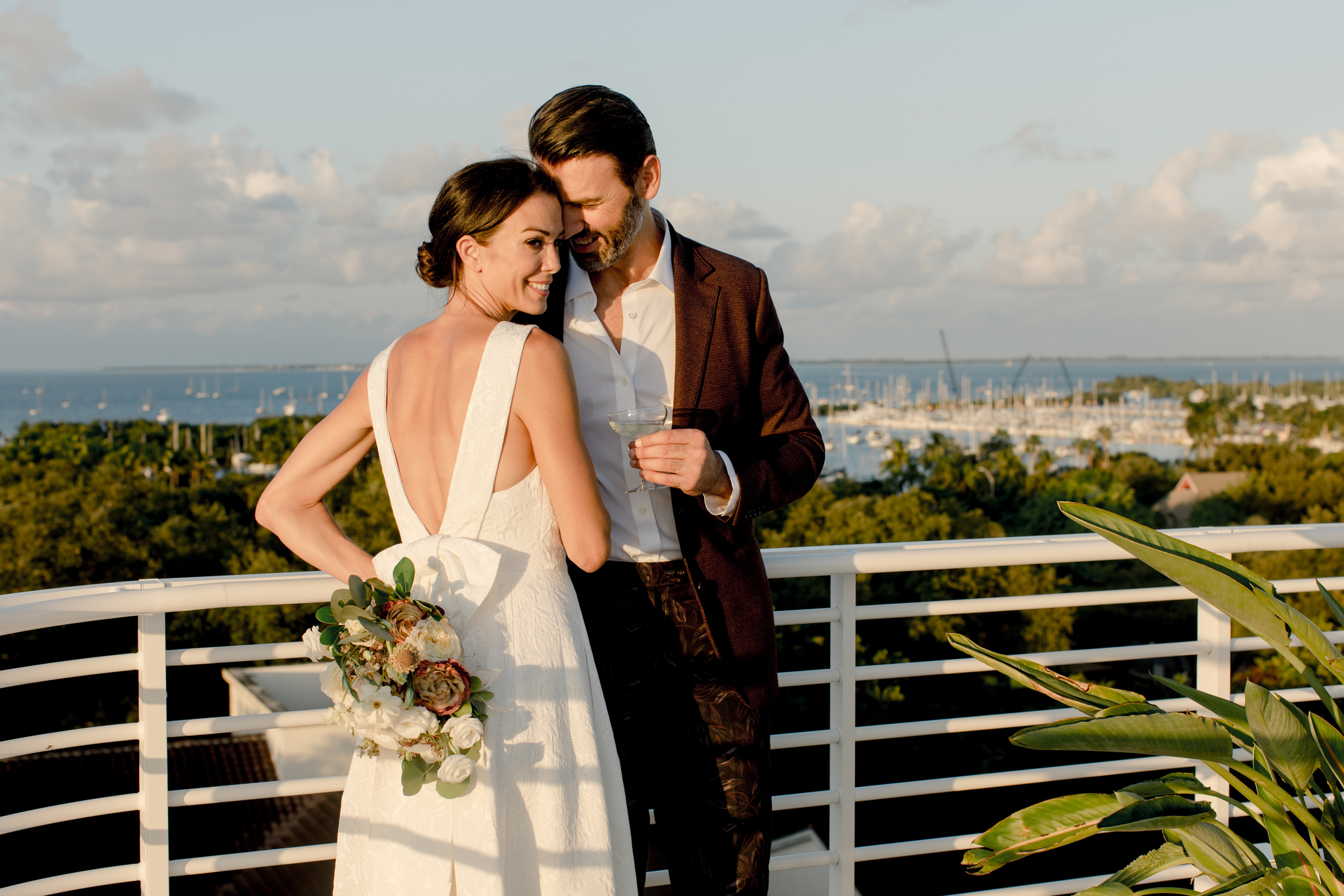 external shot of bride and groom overlooking coast